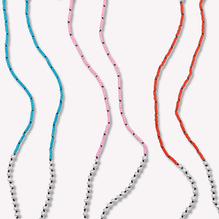 Freshwater Pearl Sawyer Pullover Necklace. Hand-knotted on black silk cord. Available colors shown are Capri Blue, Cotton Candy Pink and Vermillion Red. $165 each. 23 inches in length. Detailed view.