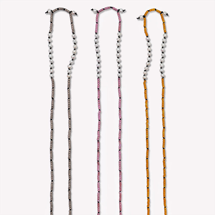 Freshwater Pearl Sawyer Pullover Necklace. Set 1.3. Hand-knotted with glass beads on black silk cord. Available colors shown are Graphite Gray, Golden Rhubarb and Sienna Brown. $165 each. 23 inches in length. Detailed image of top half.